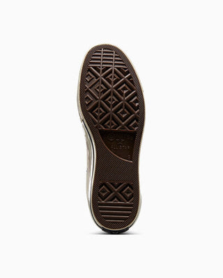 Close-up of a brown shoe sole with a white background