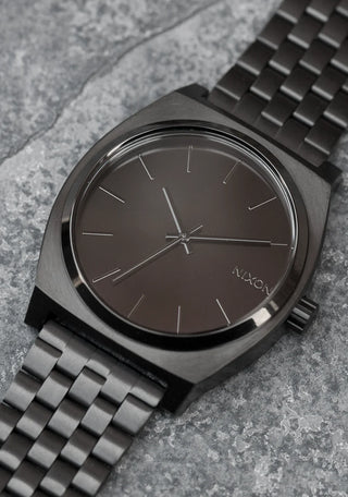 An image of the Nixon Time Teller Black watch, showcasing its sleek black design and stainless steel bracelet.
