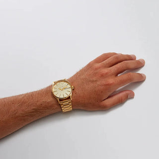 Image of the Nixon Sentry Stainless Steel All Gold watch, showcasing its all gold design and stainless steel bracelet.