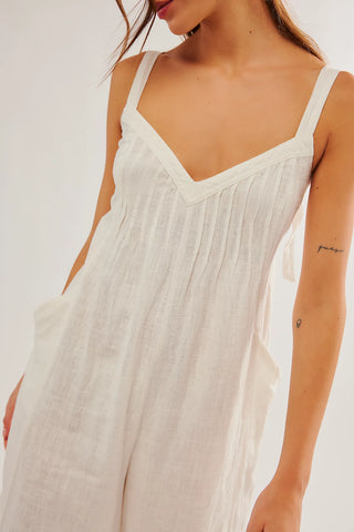 Free People one-piece in Snowbell, sweetheart neckline, pleated bust, wide-leg fit, open back with tie closures.