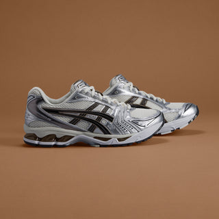 ASICS Kayano 14 sneakers in a Cream/Black colorway, blending retro aesthetics with layered leather and mesh construction for a stylish, sustainable design.