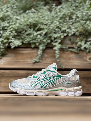 Image of the side view of the ASICS GEL-NYC Kale Pack on a wooden bench in front of some greenery