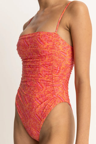 Orange paisley one-piece swimsuit with scrunched sides and high-cut leg.