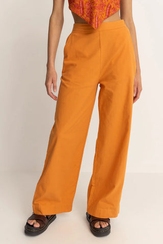 Orange wide leg pants with high tailored waistband and relaxed fit.