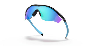 Oakley M2 Frame XL sunglasses in Polished Black with Prizm Sapphire lenses, lightweight O Matter frame with ellipse metal icon accents, Unobtainium earsocks and nosepads, HDO performance shield lens, interchangeable lens system, enhanced XL vertical lens dimension for cycling and sport