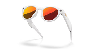 Oakley Meta HSTN smart glasses in Warm Grey with Prizm Ruby lenses, Meta AI, camera, and audio.
