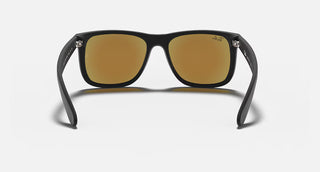 Ray-Ban Justin Sunglasses RB4165 in Matte Rubber Black with Blue Mirror Flash lenses, square rectangle nylon frame with rubberized finish and black temples, 54mm lens width, 43.9mm lens height, 145mm temple length, Wayfarer-inspired bold style