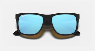 Ray-Ban Justin Sunglasses RB4165 in Matte Rubber Black with Blue Mirror Flash lenses, square rectangle nylon frame with rubberized finish and black temples, 54mm lens width, 43.9mm lens height, 145mm temple length, Wayfarer-inspired bold style