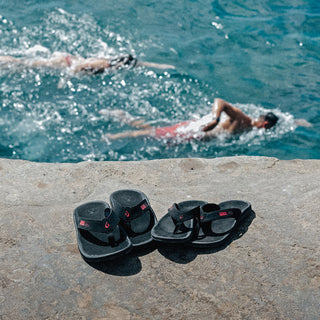 OluKai 'Ohana Men's Beach Sandals in Black/HLA, water-resistant synthetic straps with quick-drying jersey knit lining, soft nylon toe post, anatomically contoured footbed, and non-marking rubber outsole