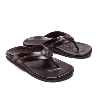 OluKai Mea Ola Leather Sandals in Dark Java/Dark Java — premium full-grain leather with canoe lash whipstitching, octopus laser-etched footbed, microfiber lining, and handsewn leather toe post