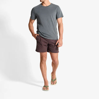 Side view of an OluKai Ulele sandal in Shadow Green with laser-cut straps, mustard-colored lining, and a textured cream sole.
