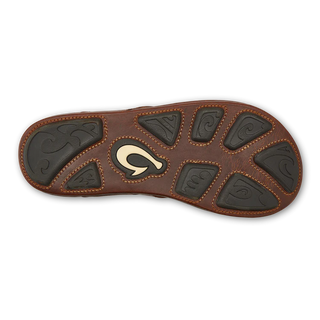 Side view of an OluKai Mekila sandal in Natural/Natural with brown leather straps, stitched edges, and decorative artwork across the footbed.