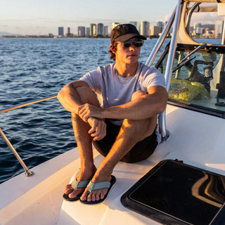 OluKai 'Ahi Kai Men's Beach Sandals in Seagreen/Trench Blue, NaluFoam cushioned midsole with secure strap design, quick-drying nylon toe post, and barnacle-inspired Wet Grip rubber outsole