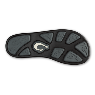 OluKai Mea Ola Mano Sandals in Black/Dark Shadow — premium full-grain leather with hand-woven Polynesian lashing details, laser-etched Mano shark artwork, flexible midsole, and cushioned footbed