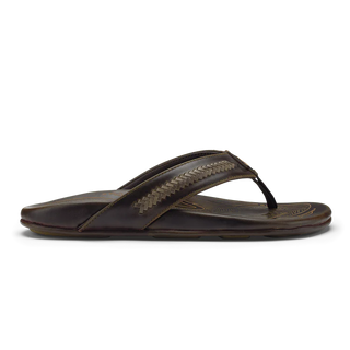 OluKai Mea Ola Mano leather sandals in Dark Java/Mustang with woven straps and shark-inspired etched detailing.