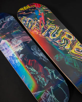Creature 9.0 inch Willis Kimbel Deep Dive skateboard deck with surreal artwork by Violet Aveline and prismatic foil underlay.