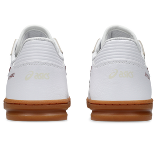 ASICS SKYHAND OG sneaker in white and brisket red with suede paneling, gum outsole, and retro handball-inspired design.