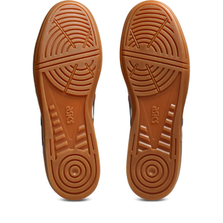 ASICS SKYHAND OG sneaker in white and brisket red with suede paneling, gum outsole, and retro handball-inspired design.