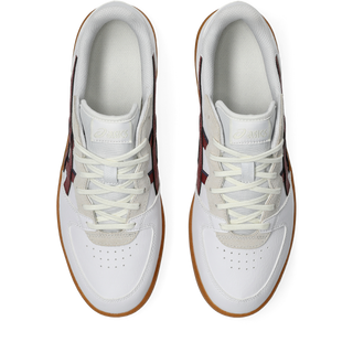 ASICS SKYHAND OG sneaker in white and brisket red with suede paneling, gum outsole, and retro handball-inspired design.