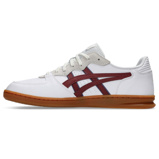 ASICS SKYHAND OG sneaker in white and brisket red with suede paneling, gum outsole, and retro handball-inspired design.