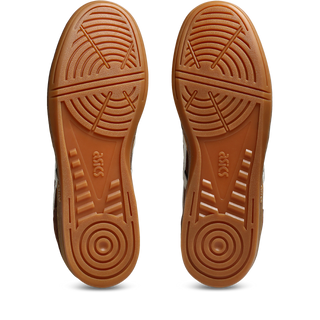 ASICS SKYHAND OG in reddish brown and oatmeal with suede panels, gum outsole, and retro handball-inspired silhouette.