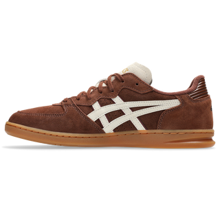 ASICS SKYHAND OG in reddish brown and oatmeal with suede panels, gum outsole, and retro handball-inspired silhouette.