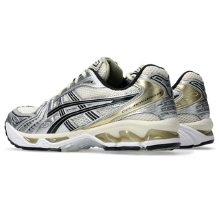 Pair of running shoes with white, black, and gold design on a white background
