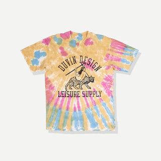 Model wearing the Duvin Leopard Tee in yellow, pink, and blue tie dye with a black leopard-and-rider graphic and Duvin Design Leisure Supply lettering