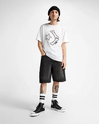 Person wearing a white t-shirt with a graphic design, black shorts, and black sneakers on a white background