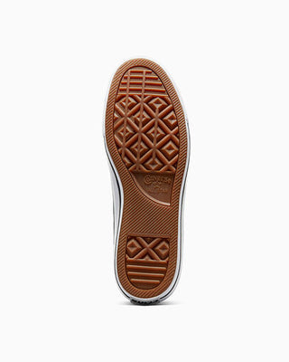 Close-up of a brown shoe sole with a pattern on a white background