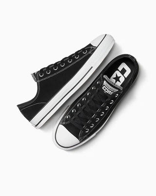 Black Converse sneakers on a white background