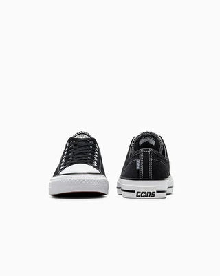 Black sneakers with white soles on a white background