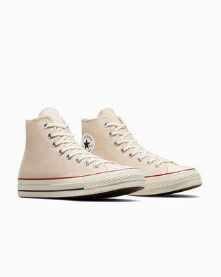 Pair of beige high-top sneakers on a white background