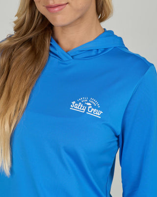 Bold blue Salty Crew hooded sunshirt with long sleeves, printed chest and back graphics, and lightweight stretch performance fabric.