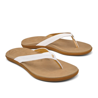 Olukai Honu women's leather beach sandals, laser-etched honu design, bright white, golden sand, durable grip.