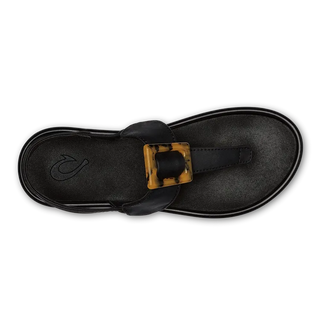 OluKai La'i T-Bar Women's Sandal in Black/Black — stretchable strap, tubular toe post, tortoise shell buckle, cushioned footbed, back strap design