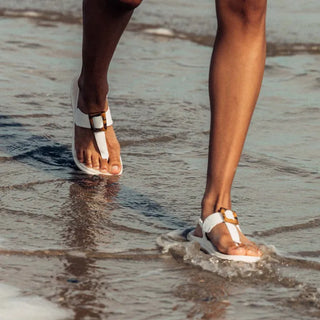 OluKai La'i T-Bar Women's Sandal in White/White — stretchable strap, tubular toe post, tortoise shell buckle, cushioned footbed, back strap design