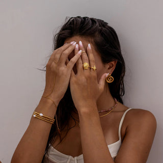 Gold conch shell-inspired ring with sculpted polished finish.