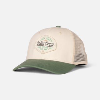 Off white and mid green Salty Crew trucker hat with woven front patch, low-crown fit, and adjustable snapback closure.