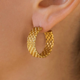 Polished gold hoop earrings with rounded classic silhouette.