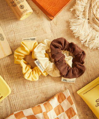 Sun Bum Limited Edition SB x Kitsch 3-piece scrunchie set in corduroy, satin, and linen.
