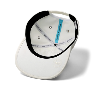  melin Eagle Hydro Hat in Egret — unstructured crushable crown, Cloud Visor Core, coated HYDRO rear panel ventilation, moisture-wicking lining, and hidden besom pocket