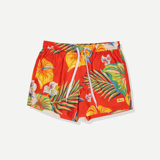 Model wearing Duvin Tropic Floral Swim Shorts in red with multicolored tropical flowers and leaves and a white drawstring