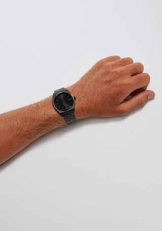 An image of the Nixon Time Teller Black watch, showcasing its sleek black design and stainless steel bracelet.