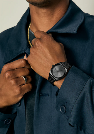 Nixon Time Teller All Black analog watch with stainless steel bracelet and minimalist black dial.