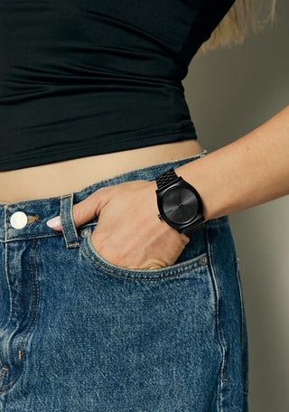 Nixon Time Teller All Black analog watch with stainless steel bracelet and minimalist black dial.