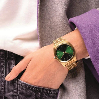 Nixon Time Teller Watch in Gold with a Green Sunray dial, stainless steel construction, and waterproof design.