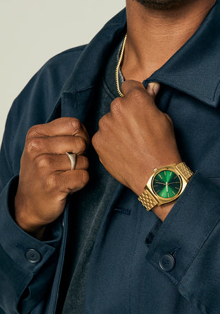 Nixon Time Teller Gold/Green Sunray analog watch with gold stainless steel bracelet and green sunray dial.