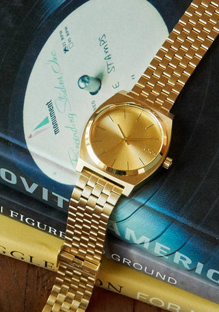 Nixon Time Teller All Gold analog watch with gold stainless steel bracelet and matching minimalist dial.