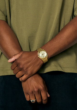 Nixon Time Teller 4th Dimension Gold/Vintage White watch with gold stainless steel bracelet and vintage white dial.
